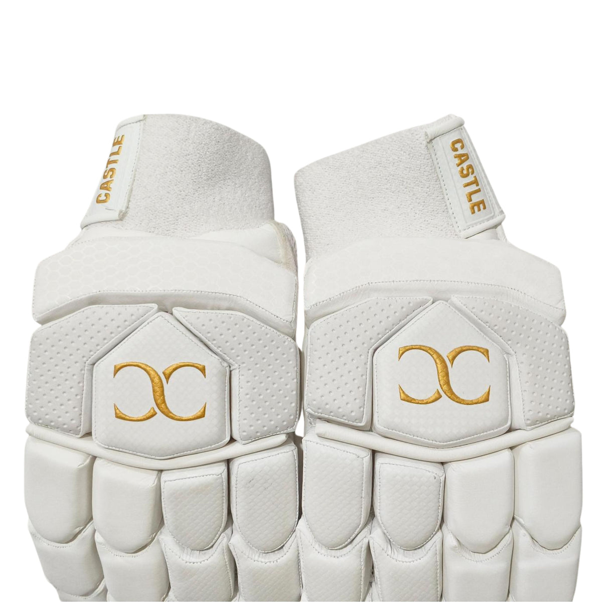 Castle white and gold batting gloves showing wrist cuffs and back-of-hand padding